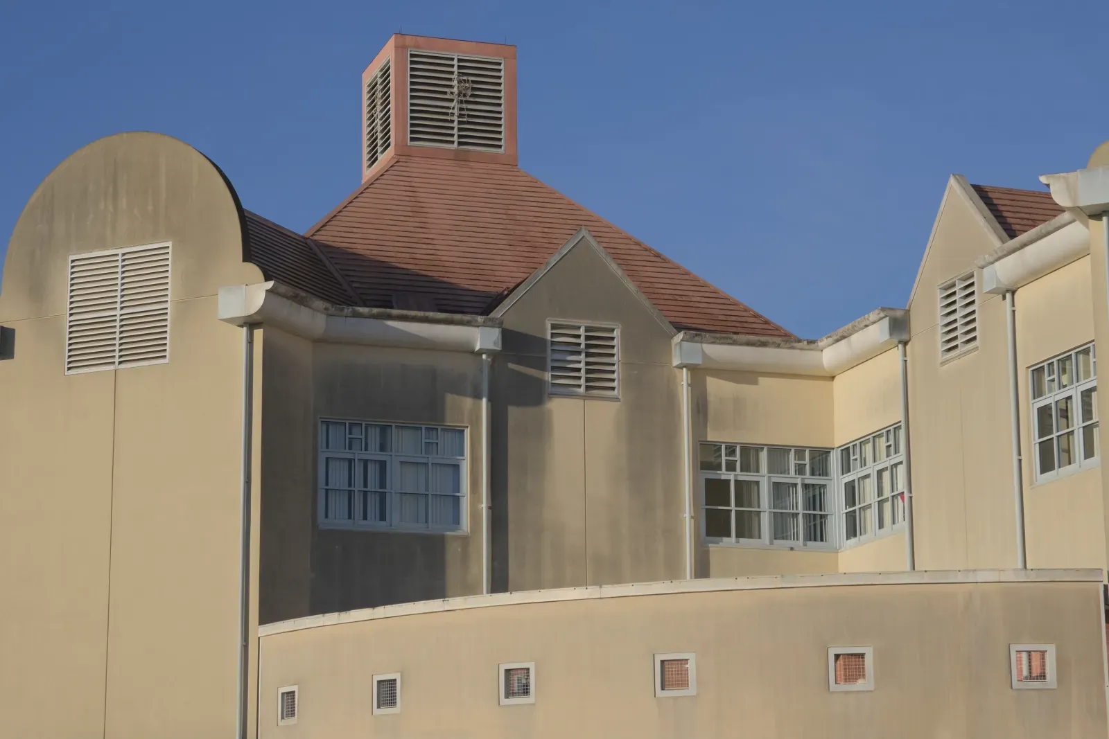 Rady Children's Hospital exterior before soft washing — visible algae, mildew, and accumulated grime on the stucco surface
